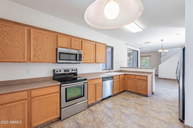 1244 S Tacoma, Mesa, AZ 85209 - kitchen with stainless steel appliances, a peninsula, a sink, a chandelier, and light countertops