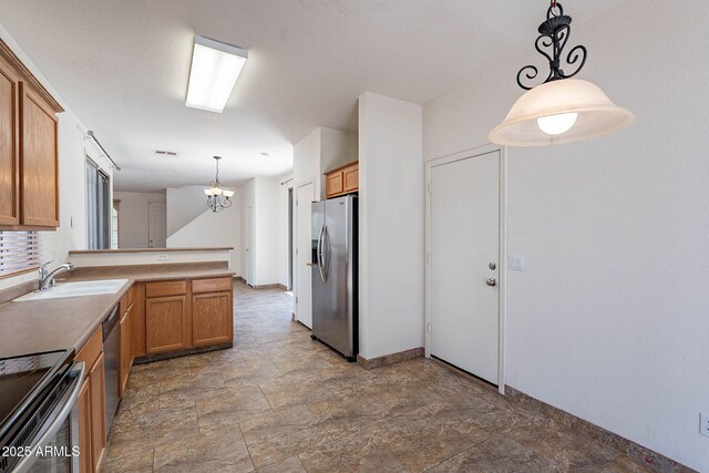 1244 S Tacoma, Mesa, AZ 85209 - kitchen featuring appliances with stainless steel finishes, a sink, stone finish floors, a peninsula, and brown cabinetry