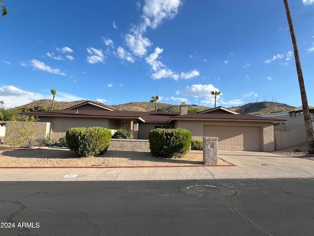 view of front of house with a mountain view and a garage