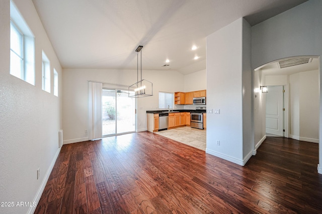 kitchen featuring pendant lighting, stainless steel appliances, dark hardwood / wood-style flooring, and sink