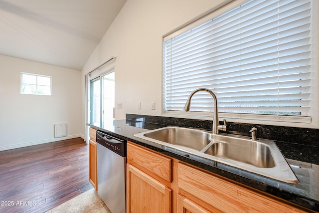 kitchen with hardwood / wood-style flooring, dishwasher, vaulted ceiling, and sink