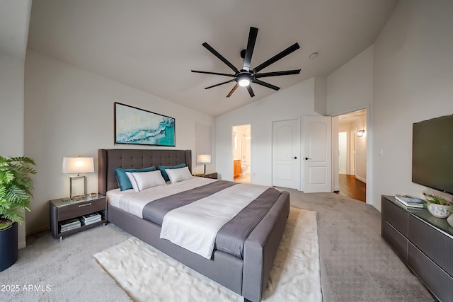 bedroom featuring lofted ceiling, light colored carpet, ceiling fan, and ensuite bathroom