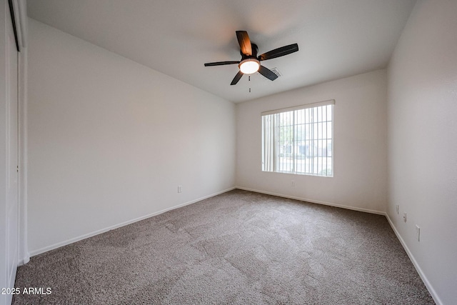 carpeted empty room featuring ceiling fan