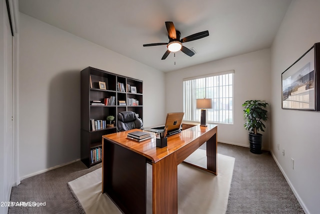 office with ceiling fan and dark colored carpet