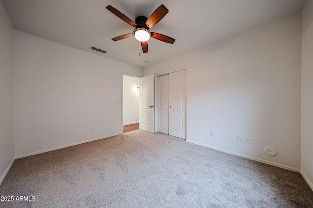 unfurnished bedroom featuring carpet, ceiling fan, and a closet