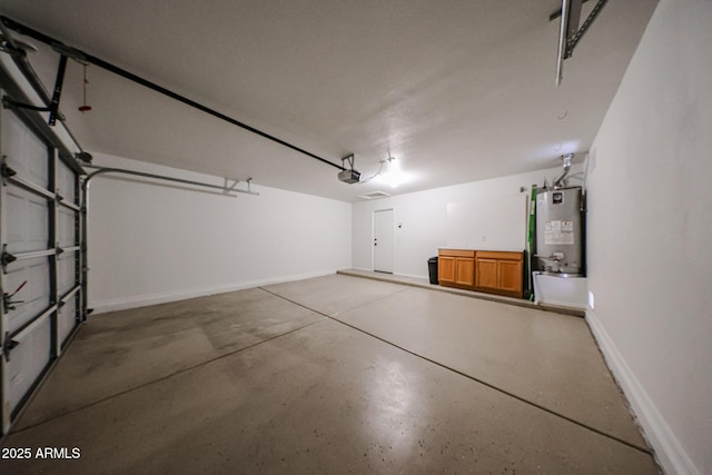 garage featuring a garage door opener and gas water heater