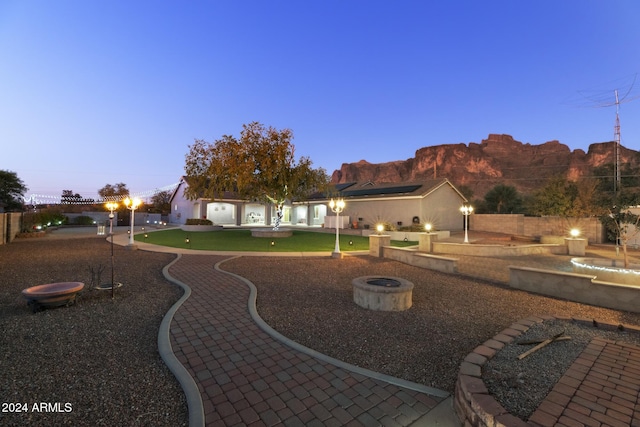 exterior space with a mountain view and an outdoor fire pit