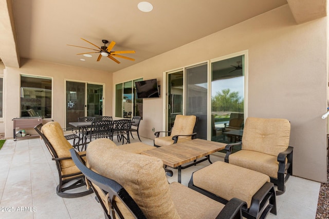 view of patio with outdoor dining space and a ceiling fan