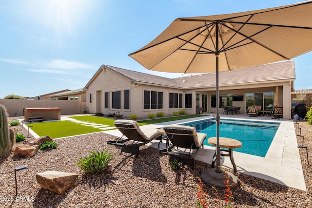 view of swimming pool with a hot tub, a fenced in pool, a fenced backyard, and a patio