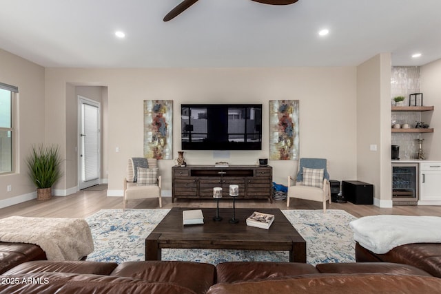 living room featuring beverage cooler, wood finished floors, ceiling fan, and recessed lighting
