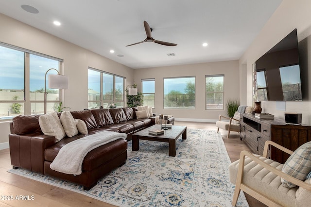 living room with a ceiling fan, baseboards, visible vents, light wood-style floors, and recessed lighting