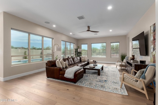 living room with recessed lighting, visible vents, light wood-style floors, and a ceiling fan
