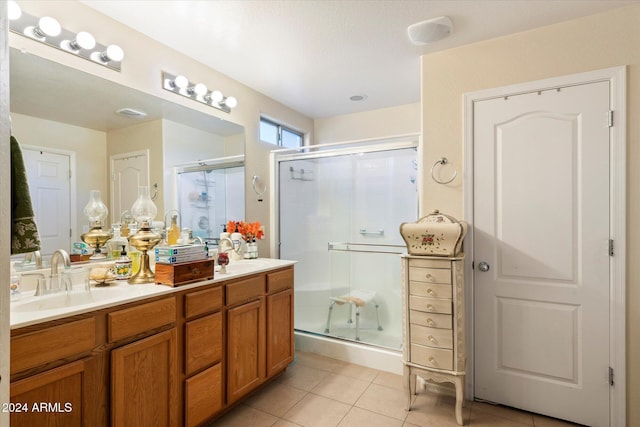 bathroom featuring vanity, tile patterned floors, and walk in shower