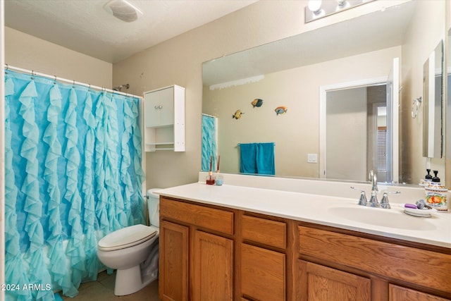 bathroom featuring vanity, a textured ceiling, and toilet