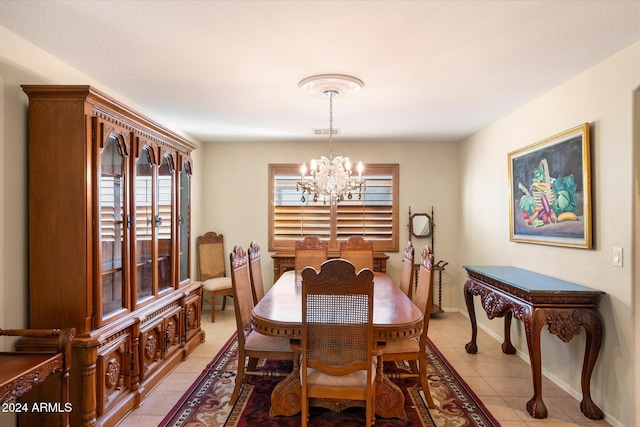 dining room featuring light tile patterned flooring and a chandelier