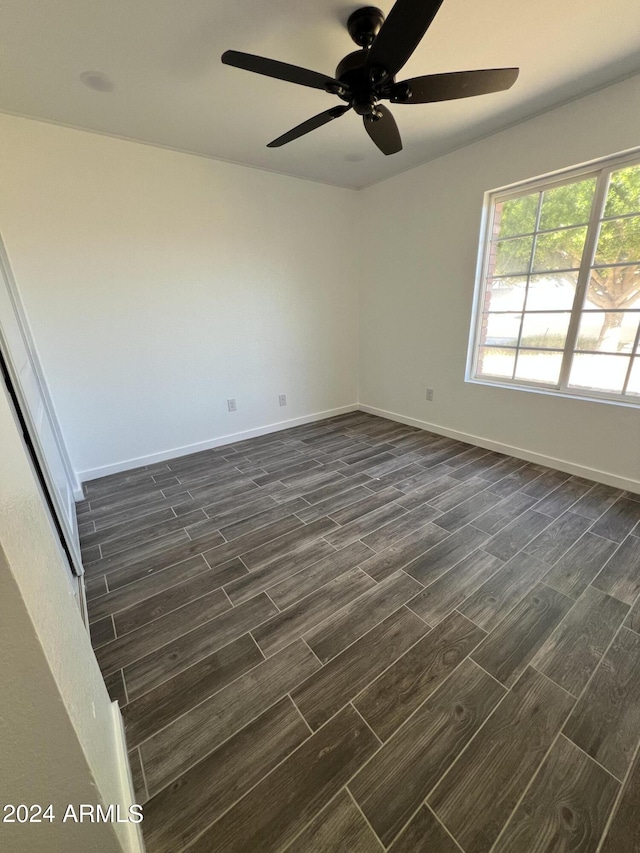 unfurnished room featuring ceiling fan and dark hardwood / wood-style flooring