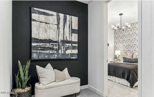 sitting room featuring carpet and a notable chandelier