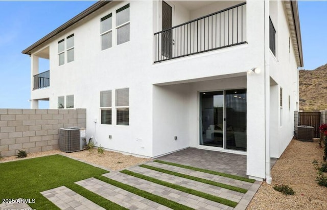 rear view of property with a patio area and central air condition unit