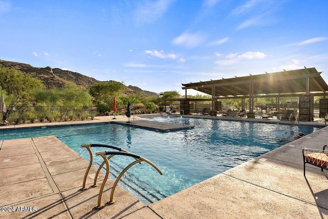 view of swimming pool featuring a mountain view and a patio