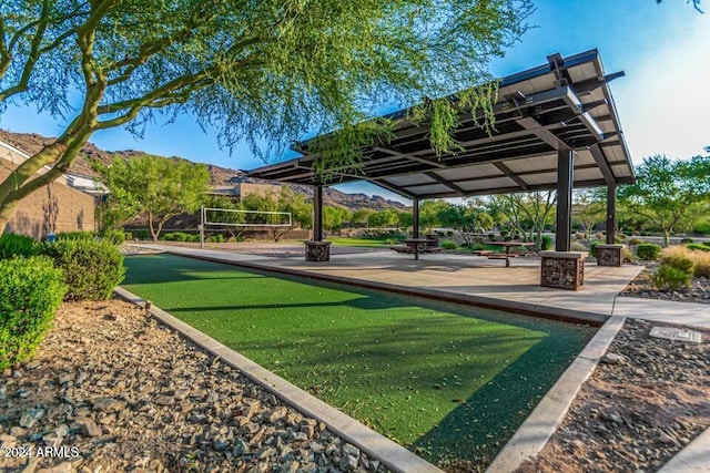 view of home's community with a mountain view and volleyball court