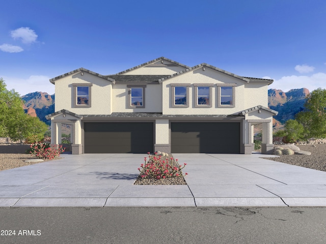 view of front of property with a mountain view and a garage