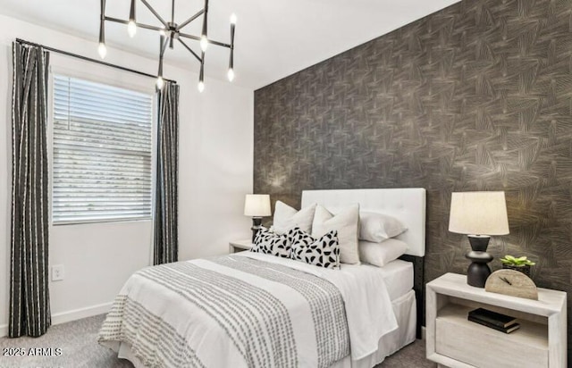 bedroom with a chandelier and dark carpet