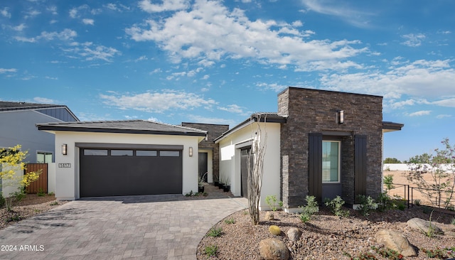 1417 E Cherrywood Pl, Chandler, AZ 85249 - contemporary home featuring stone siding, stucco siding, decorative driveway, and a garage