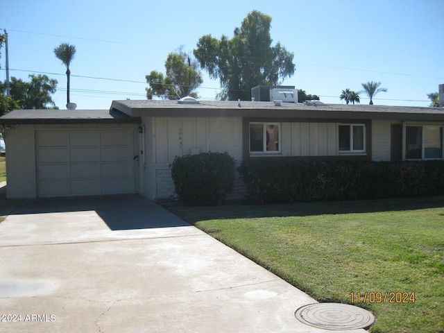 single story home featuring a garage and a front yard