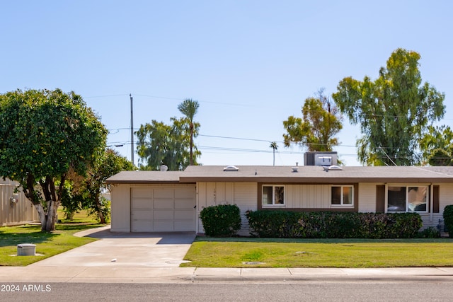 ranch-style home with a front yard and a garage