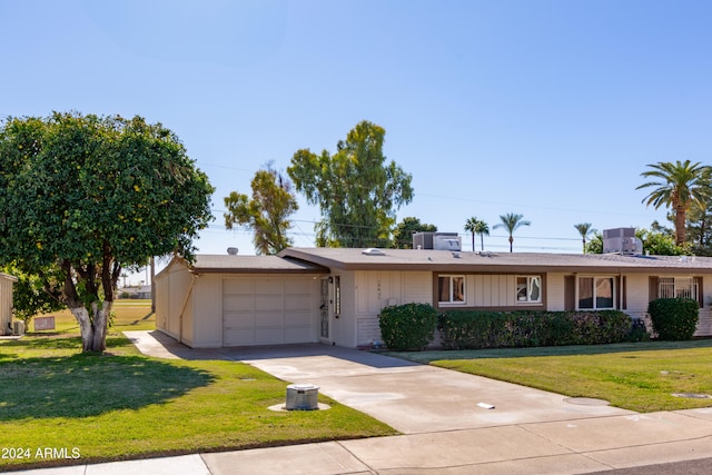 single story home featuring a garage and a front lawn