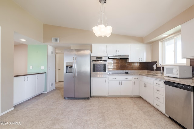 kitchen with stainless steel appliances, sink, white cabinetry, hanging light fixtures, and lofted ceiling