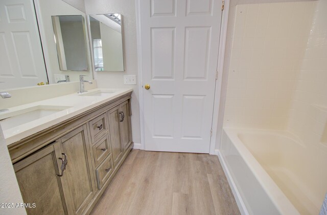 418 E 5th St, Eloy, AZ 85131 - bathroom with wood finished floors and double vanity