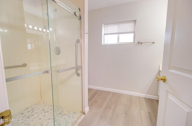 418 E 5th St, Eloy, AZ 85131 - bathroom with a stall shower, wood finished floors, and baseboards