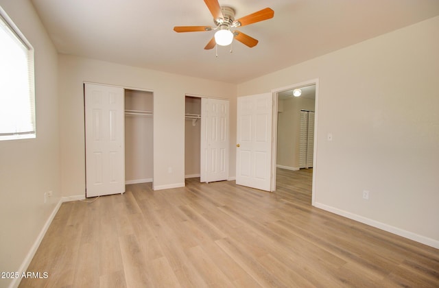 418 E 5th St, Eloy, AZ 85131 - unfurnished bedroom with multiple closets, light wood-type flooring, baseboards, and a ceiling fan