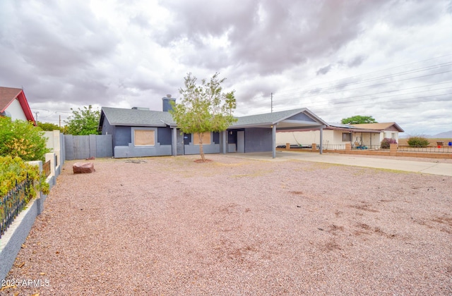 418 E 5th St, Eloy, AZ 85131 - ranch-style house featuring a carport, fence, a chimney, and driveway