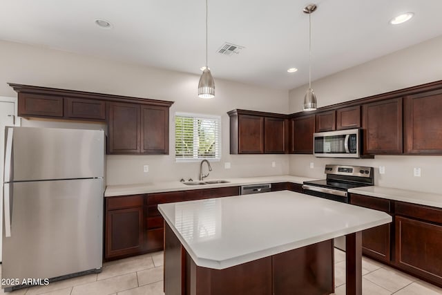 2000 N 36th St Unit 14, Phoenix, AZ 85008 - kitchen with appliances with stainless steel finishes, light tile patterned floors, dark brown cabinetry, light countertops, and recessed lighting