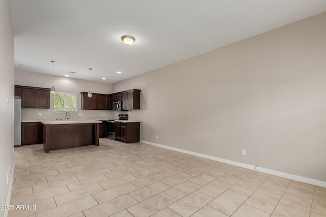 2000 N 36th St Unit 14, Phoenix, AZ 85008 - kitchen with stainless steel appliances, light countertops, open floor plan, dark brown cabinets, and recessed lighting
