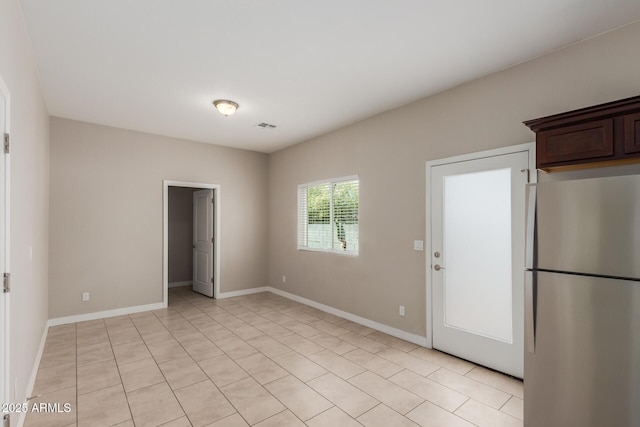 2000 N 36th St Unit 14, Phoenix, AZ 85008 - kitchen with freestanding refrigerator, dark brown cabinetry, and light tile patterned floors