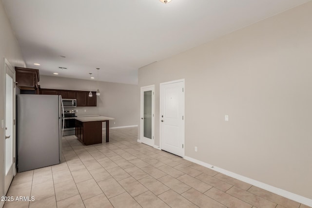 2000 N 36th St Unit 14, Phoenix, AZ 85008 - kitchen featuring appliances with stainless steel finishes, dark brown cabinetry, light countertops, recessed lighting, and a center island