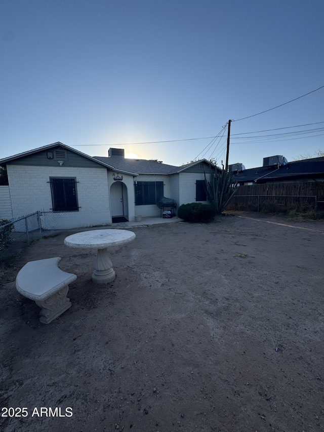 418 N 14th St, Phoenix, AZ 85006 - rear view of property featuring brick siding and a chimney