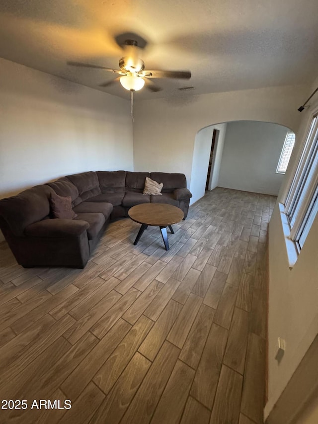 418 N 14th St, Phoenix, AZ 85006 - living room with arched walkways, wood finished floors, and ceiling fan