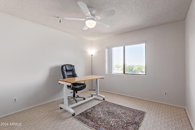 carpeted office space featuring a textured ceiling and ceiling fan