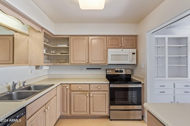 kitchen with light brown cabinetry, sink, light tile patterned floors, and stainless steel appliances