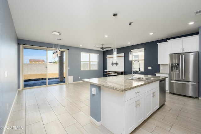 12568 W Orangewood Ave, Glendale, AZ 85307 - kitchen featuring a sink, stainless steel appliances, decorative light fixtures, baseboards, and a ceiling fan