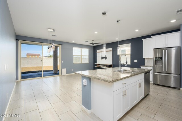 12568 W Orangewood Ave, Glendale, AZ 85307 - kitchen featuring a sink, stainless steel appliances, decorative light fixtures, baseboards, and a ceiling fan