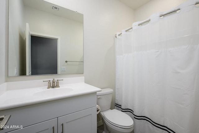 bathroom with vanity, toilet, and walk in shower