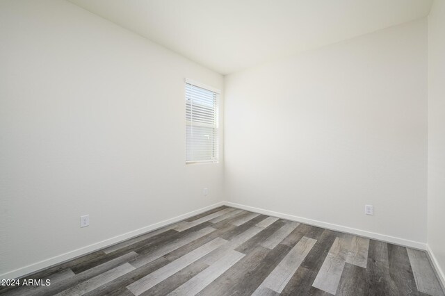 12568 W Orangewood Ave, Glendale, AZ 85307 - unfurnished room with dark wood-style flooring and baseboards