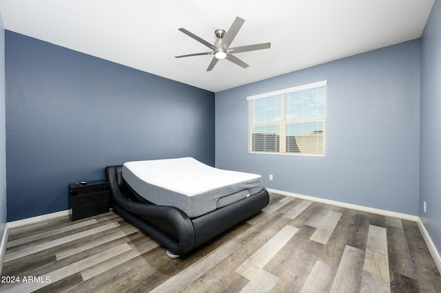 bedroom with ceiling fan and wood-type flooring