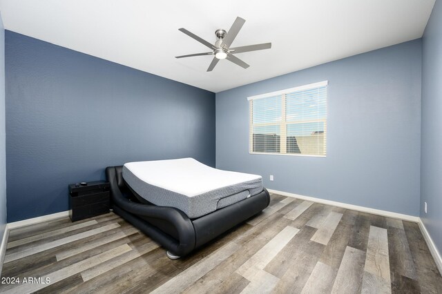12568 W Orangewood Ave, Glendale, AZ 85307 - bedroom with baseboards, ceiling fan, and wood finished floors