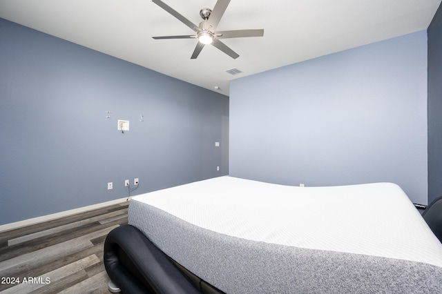 bedroom featuring dark hardwood / wood-style floors and ceiling fan